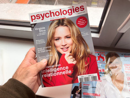 POV male hand holding psychologies magazine with Virginie Efira