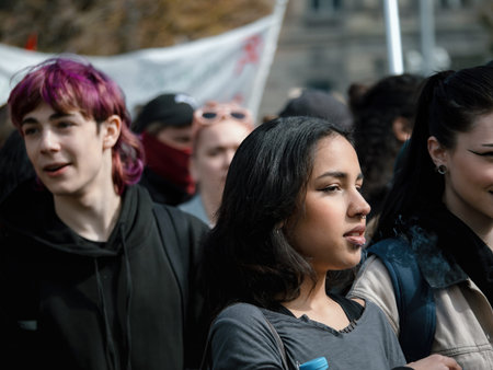 A large group of adults and young people protesting in France, u