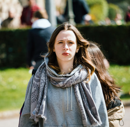A young adult woman with long brown hair and nose piercing lookのeditorial素材