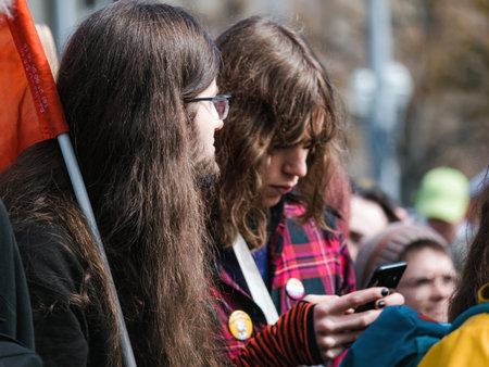 Young people texting while protesting in Strasbourg - France exp