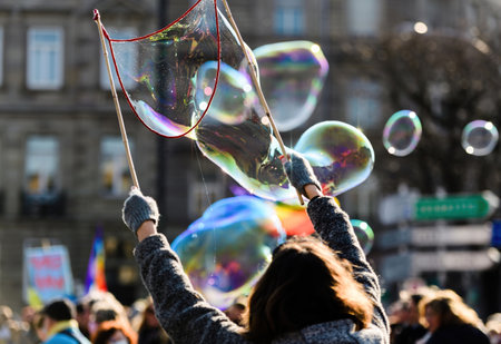 Urban Woman Having Fun Making Soap Balloonsの写真素材