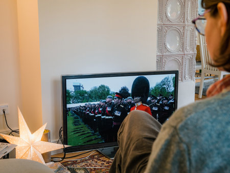 Woman watching The Coronation of Charles III and his wife, Camillaのeditorial素材