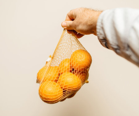 Holding Healthy Mandarines for Wellbeingの写真素材