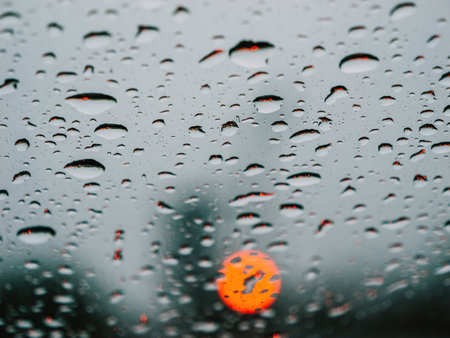 Rainy road: Red light commute in wet monsoon seasonの写真素材