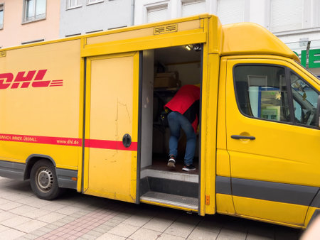 Yellow DHL delivery vehicle in german cityのeditorial素材
