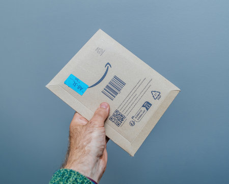 A Secure Delivery: Hand Holding a Amazon Prime Parcel.のeditorial素材