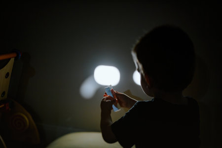 Curious toddler explores crystal light prism reflectionsの写真素材