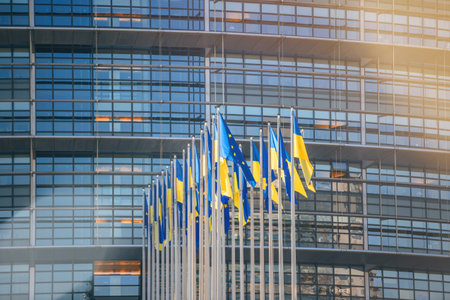 24 Ukrainian flag flies next to the Flag of Europeの写真素材