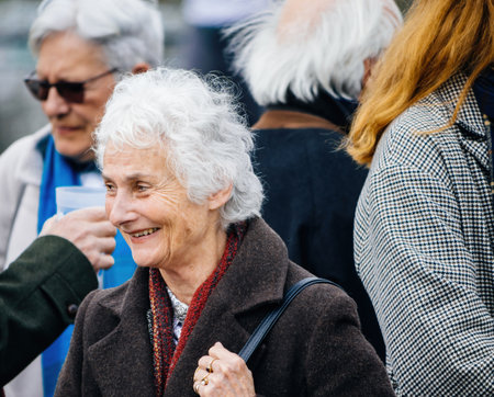 Smiling senior woman peacefully protest in front of the Europeanのeditorial素材
