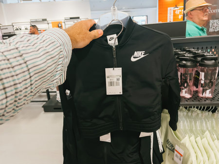 Male hand shopping for womens nike clothes in outlet store