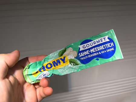 Delicious gourmet mayonnaise held by mans hand