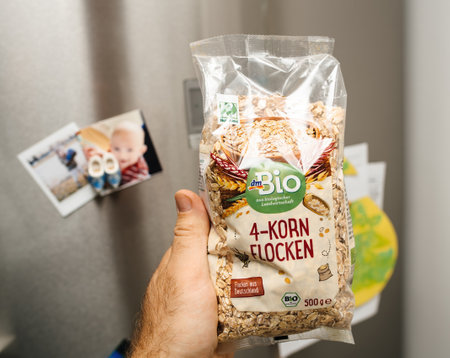 POV personal perspective male hand holding DM Bio 4-korn flocken cereals issued from organic agricultureのeditorial素材