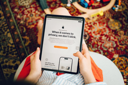Mobile communication: Woman reading about Apple Privacyのeditorial素材