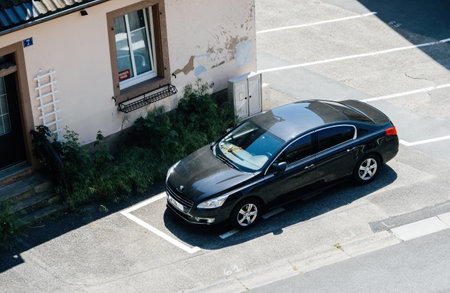 An overhead shot showcasing a sleek black Peugeot car parked inのeditorial素材