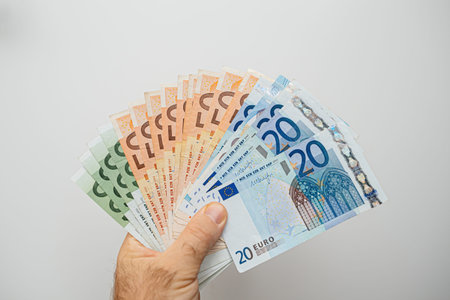 Person Holding Money in Hand