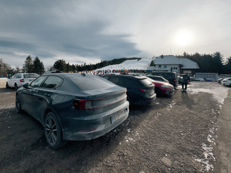 Germany - Jan 21, 2024: An electric exclusive Swedish Polestar car parked in the large parking area of Seebach Ski Resort, with a vast slope in the background on a winter frozen dayのeditorial素材