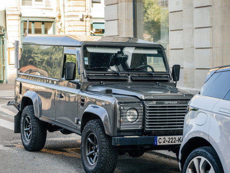 Strasbourg, France - Jul 2, 2023: Classic Land Rover Defender parked on a European urban street with...