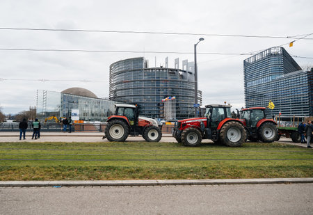 Strasbourg, France - Feb 6, 2024: PProtesters block tram and street, obstruct EU Parliament entrance, protesting food standards and GMOsのeditorial素材