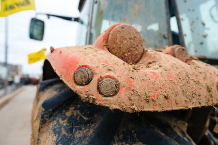 Strasbourg, France - Feb 6, 2024: The rear part of a tractor, obscured by mud, contributes to the blockade at the European Parliament entrance, part of a protest against imported food standards and new GMOs.のeditorial素材