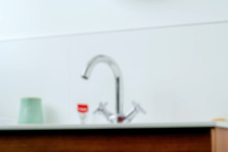 concept of a morning routine with a defocused view of a bathroom tap, accompanied by toothpaste...