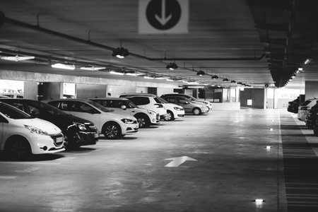 An underground parking lot offers a secure space for cars, sheltering them from weather and potential theft in monochrome tonesのeditorial素材
