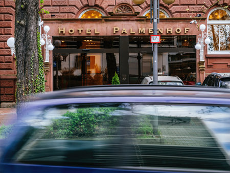 Frankfurt, Germany - Mar 31, 2024: The historic Hotel Palmenhoff in Frankfurt, Germany, captured as a car drives by on a sunny day.のeditorial素材