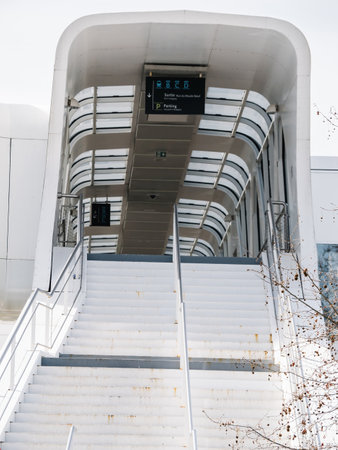 Staircase leading up to the Haguenau train station in Alsace, France, featuring modern architecture with clear signage and a glass-covered walkwayの写真素材