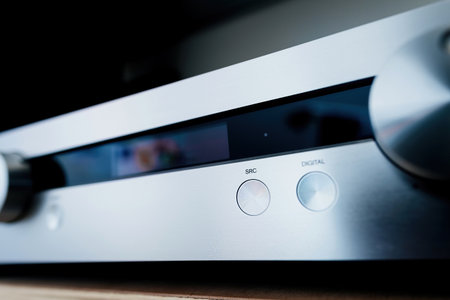Display of the power preamplifier with SRC source button, focused on the aluminum panel, highlighting the sleek design and functionality of the high-end audio equipmentのeditorial素材