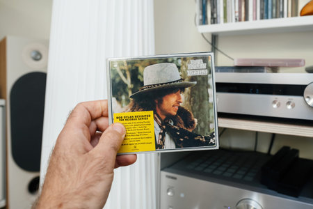 Paris, France - Jun 3, 2024: Man holding a Bob Dylan Desire SACD from the Reissue Series,...