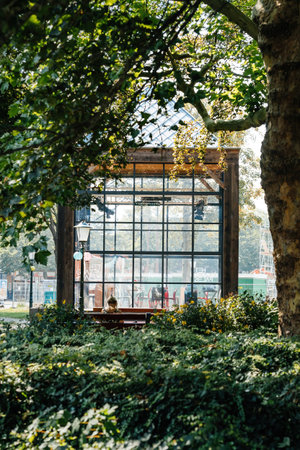 Texel, The Netherlands - Aug 27, 2019: Glass-walled building surrounded by lush greenery in Texel,...