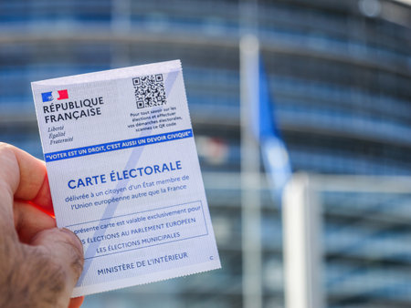 Strasbourg, France - Jun 6, 2024: A person holding a French electoral card with a QR code in front of the European Parliament building in Strasbourg, emphasizing the significance of the 2024 EU elections and the civic duty to vote.のeditorial素材