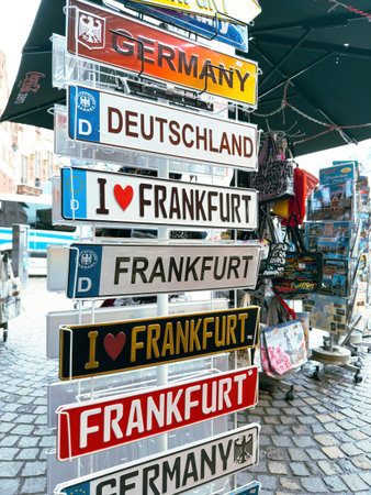 Frankfurt, Germany - Apr 1, 2024: A display rack filled with various Germany and Frankfurt signs in a Frankfurt souvenir shop, showcasing popular tourist merchandise in a vibrant outdoor market settingのeditorial素材