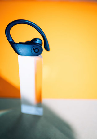 Paris, France - Sept 29, 2022: Vertical view of Powerbeats Pro sports headphones by Beats and Apple...