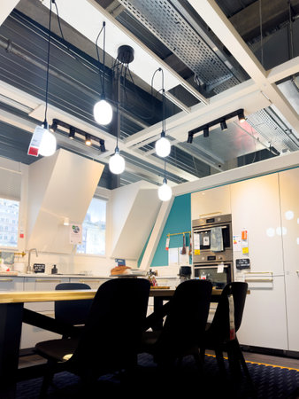 Paris, France - Jul 12, 2024: Modern kitchen inside IKEA furniture showroom, featuring multiple lights and home appliances, showcasing a sleek and functional designのeditorial素材