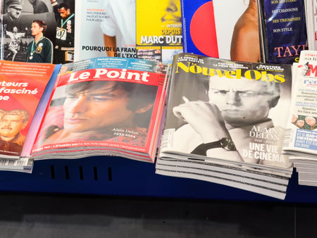 Paris, France - Aug 23, 2024: Description: French newspapers and magazines featuring Alain Delon on the cover following his death, capturing tributes and reflections on his legendary careerのeditorial素材