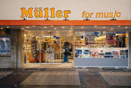 Kehl, Germany - Nov 18, 2019: A storefront of MÃÂ¼ller for Music, featuring various music and electronic products, showcasing a well-lit and organized retail space in a city settingのeditorial素材