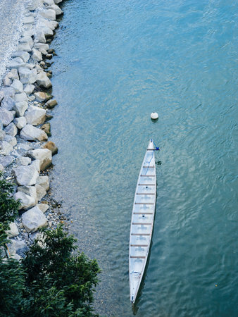 Aerial view of the Rhine River in Basel, Switzerland, featuring a leisure boat cruising through the water, surrounded by scenic urban and natural landscapes.の写真素材
