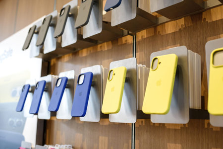 Paris, France - Sep 20, 2024: Blue and yellow iPhone 16 Pro cases on stands inside Apple Store,...