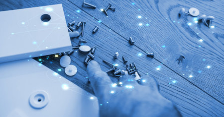 A scene of scattered screws and assembly parts, enhanced with a futuristic digital network overlay,...