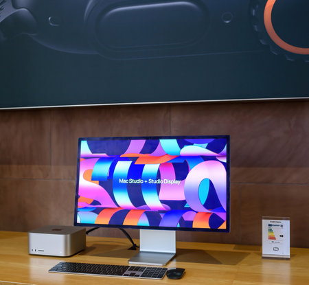 Paris, France - Sep 20, 2024: Mac Studio with Studio Display, black keyboard, and Magic Mouse on a wooden table. Focus on energy consumption of the devices in a minimalist workspaceのeditorial素材