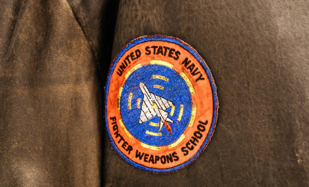 Palma, Spain A close-up of a United States Navy Fighter Weapons School patch, stitched onto a worn leather jacket, representing military aviation trainingのeditorial素材