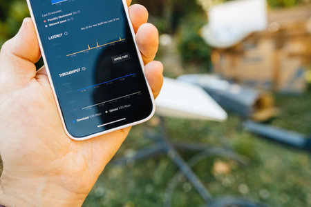 Frankfurt, Germany - Jun 15, 2023: An iPhone showing the Starlink apps speed test results with latency and throughput data, evaluating performance of the satellite-based internet connectionのeditorial素材