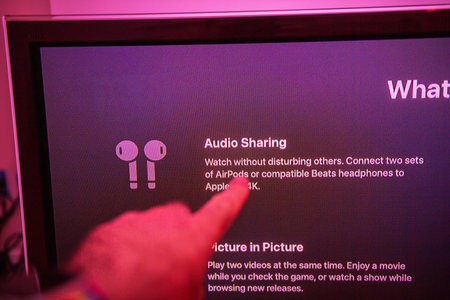 Frankfurt, Germany - Oct 20, 2020: Close-up of a finger pointing to the Audio Sharing feature on an...