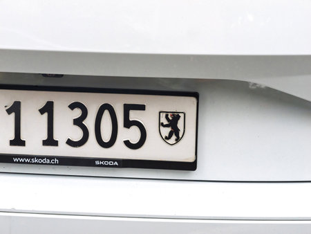 Basel, Switzerland - Sep 8, 2024: Close-up of a Swiss license plate featuring the black bear emblem on a white shield, representing the canton of Zurich, Switzerlandのeditorial素材