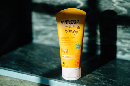Paris, France - Nov 6, 2020: Weleda Baby Calendula body wash and shampoo in yellow packaging, highlighting gentle, organic skincare for infants with natural ingredientsのeditorial素材