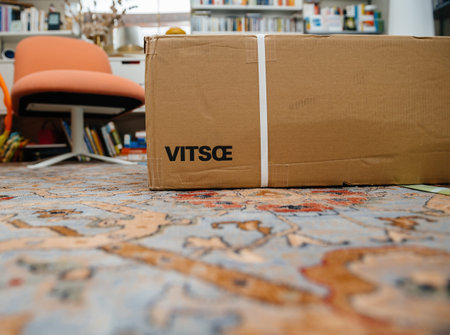 Frankfurt, Germany - Aug 21, 2024: Low-angle view of a Vitsoe shelf cardboard box placed on a wool...