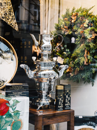 Baden-Baden, Germany - Dec 1, 2024: Elegant holiday storefront display featuring a polished silver...