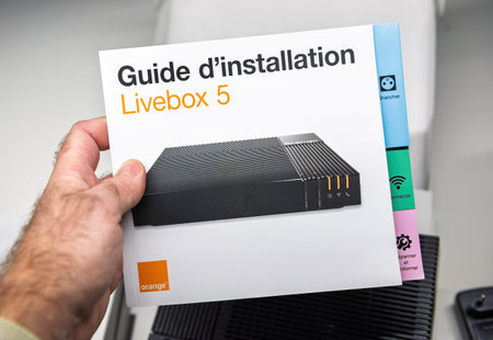 Paris, France - Nov 19, 2021: Close-up of the Orange Livebox 5 installation guide, featuring a clean...