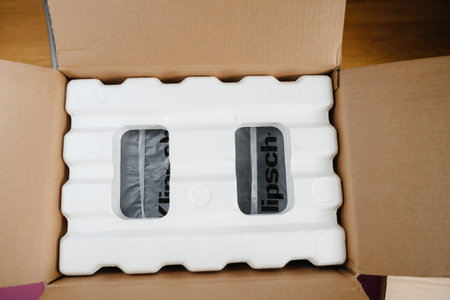 Paris, France - Apr 18, 2023: Two Klipsch speakers neatly packed in a cardboard box, wrapped...
