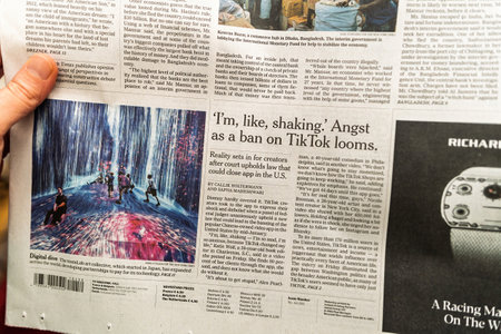 Paris, France - Dec 9, 2024: Close-up of a newspaper page featuring an article about TikToks potential ban in the U.S., alongside an image of a teamLab digital art installationのeditorial素材